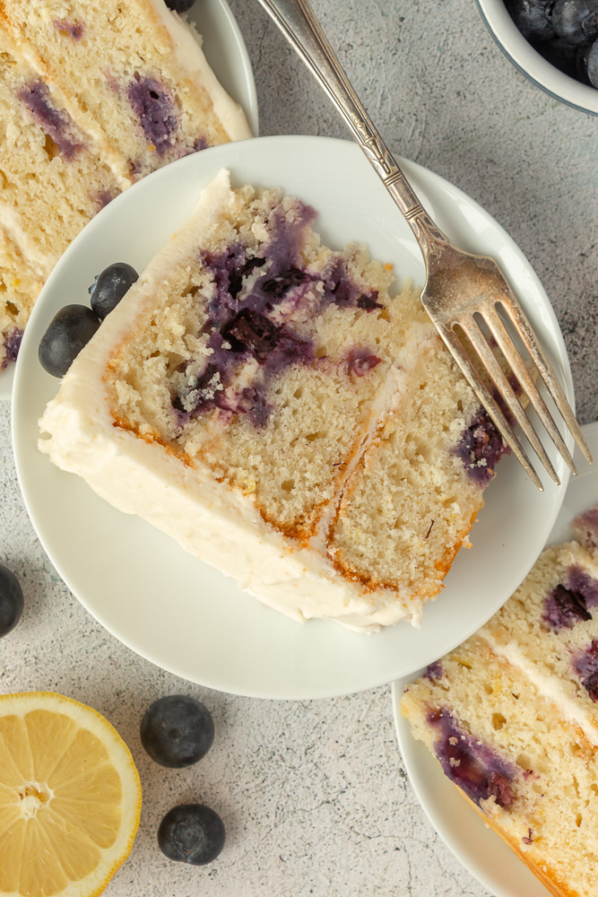 Simple blueberry layer cake overhead shot. 3 slices on plates.